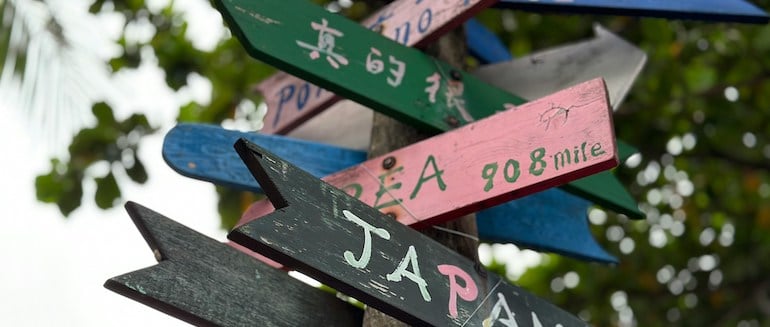 sign posts with many colored signs